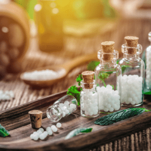 Close-Up Of Herbs And Homeopathic Medicine In Tray On Table